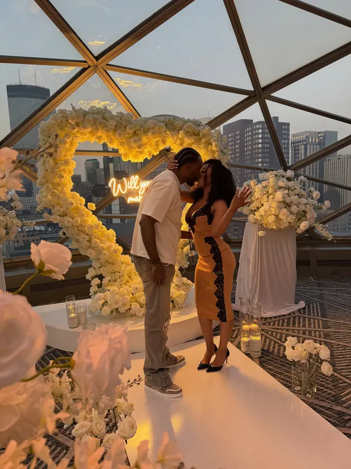 Floral heart proposal under a glass dome