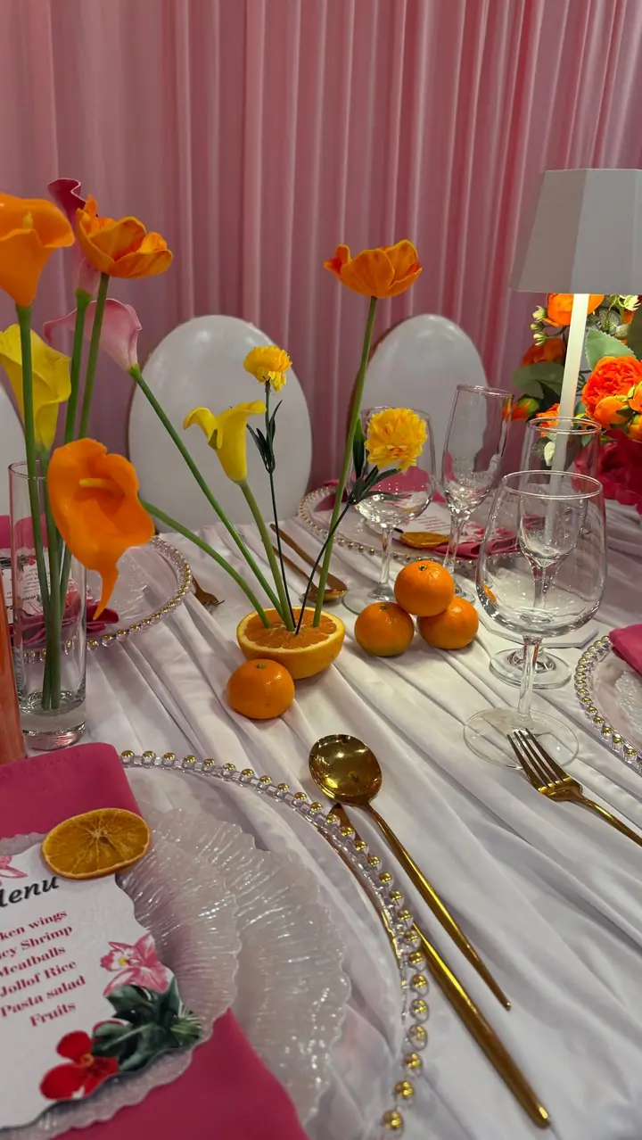 Styled table with orange florals and clear accents