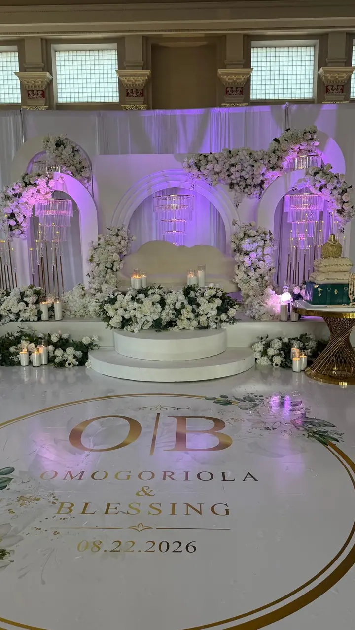 Wedding stage with white florals and monogram floor